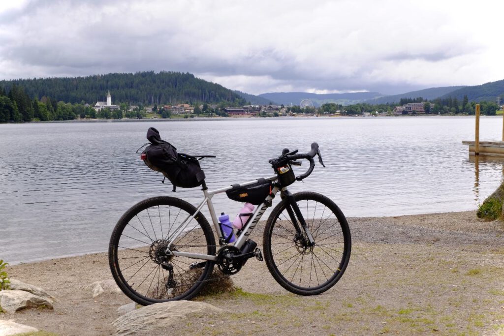 Gravel bike at Lake Titi in Black Forest, Germany. On the other lake side you can see the town of Titisee-Neustadt